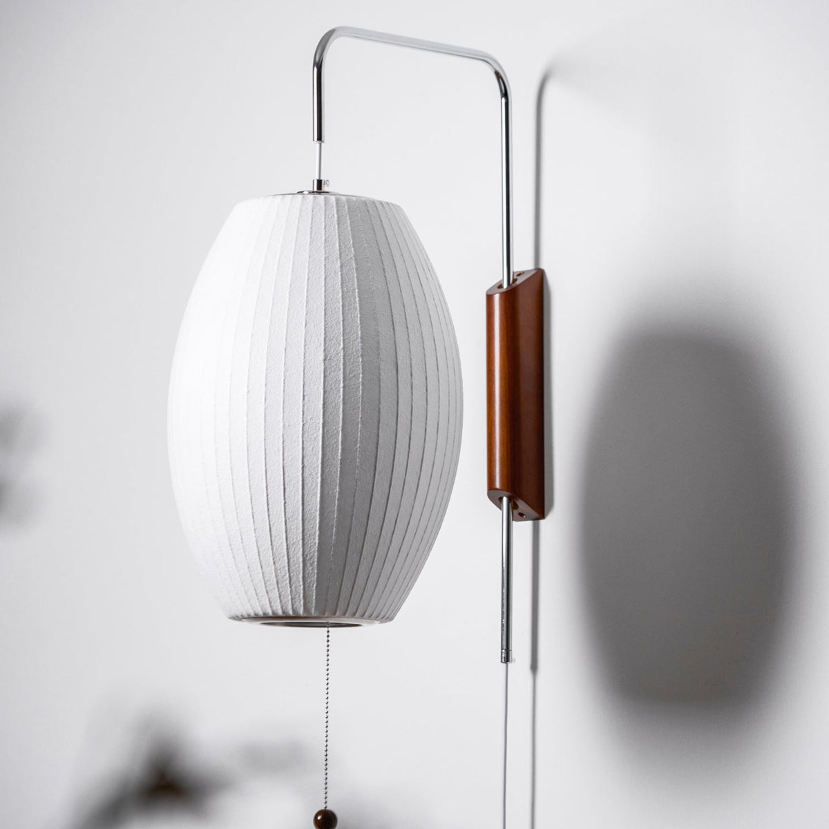 Ribbed Oval Wall Sconce With Pull Chain And Curved Arm