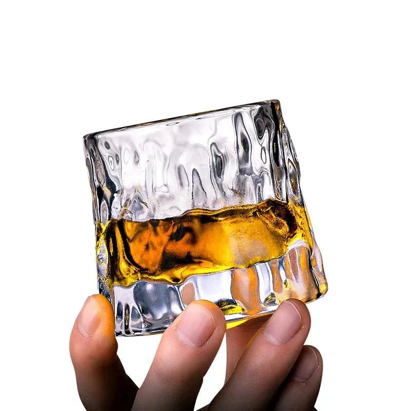 Rotating Whisky Glass with Textured Tilted Base for Swirling Spirits