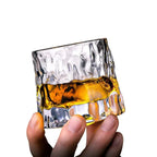 Rotating Whisky Glass with Textured Tilted Base for Swirling Spirits