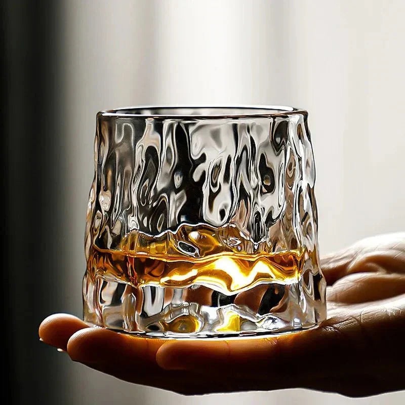 Rotating Whisky Glass with Textured Tilted Base for Swirling Spirits