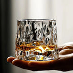 Rotating Whisky Glass with Textured Tilted Base for Swirling Spirits